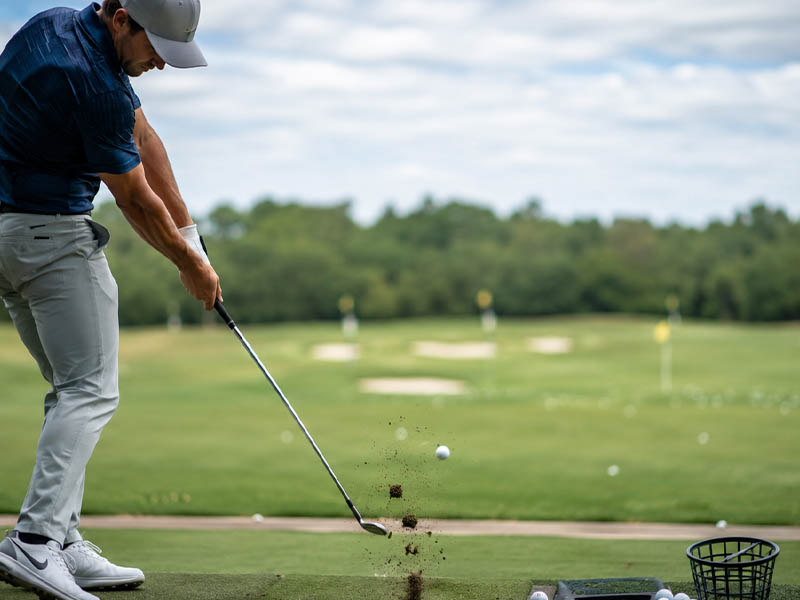 Golfer practicing on the driving range.